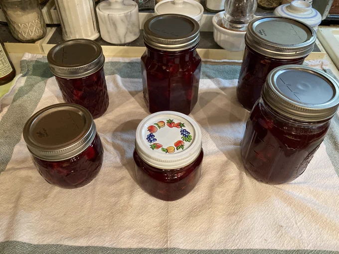 Jars of jam on a towel on the counter