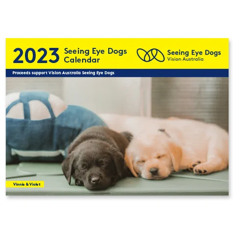The cover of the 2023 Seeeing Eye Dogs calendar featuring two puppies sleeping beside each other.