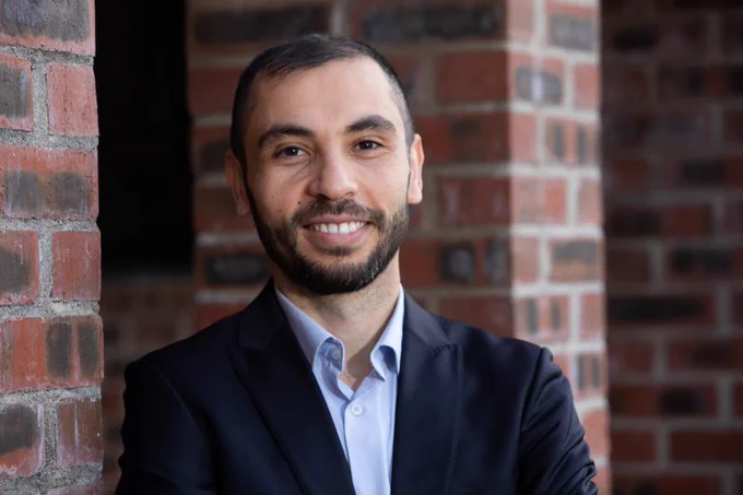 Dr Haithem Afli smiling into the camera.