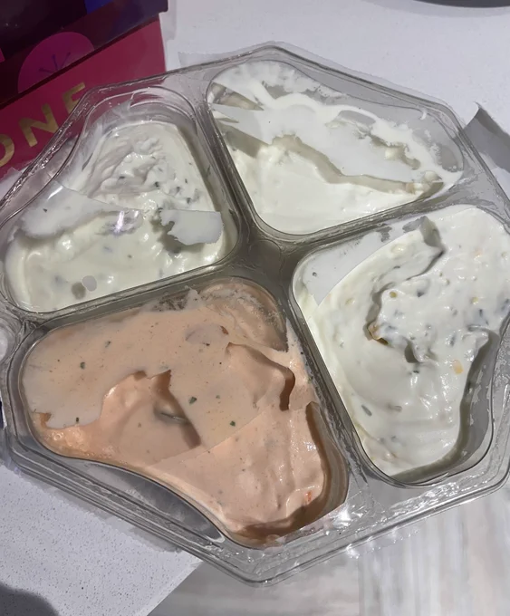 A quadrant of dips with the film all ripped up on top.