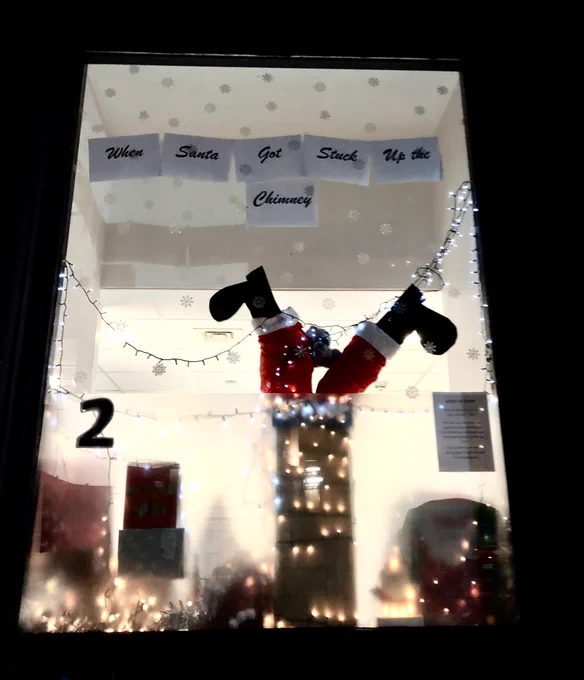 Image of Santa’s legs upside down stuck in a chimney with the number 2 ascent number next to it.