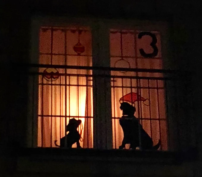 Image of two dogs in silhouette, one with a Santa hat on and the number 3 advent number.