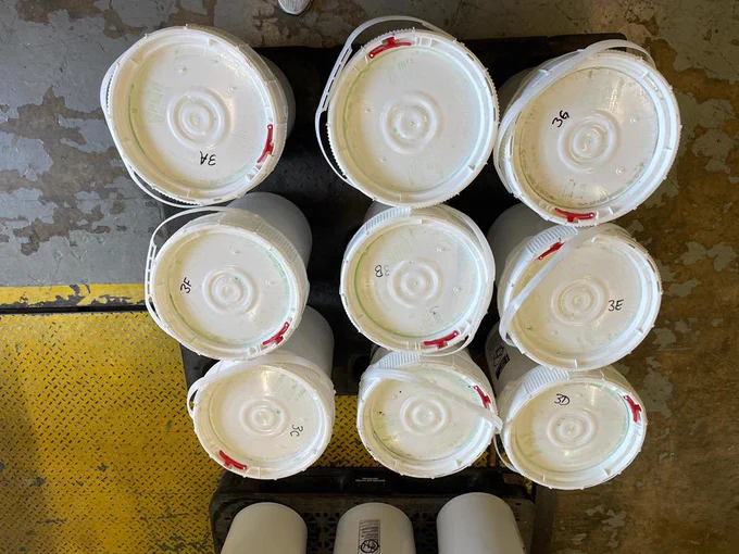 Buckets containing 913 pounds of methamphetamine