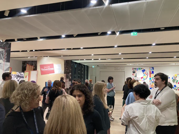 A room full of people holding wine glasses and chatting at the V&A Dundee