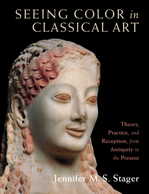 Cover of the book Seeing Color in Classical Art. Against a black background the head and face of a painted marble statue of a woman looks out. Traces of red paint cover her wavy hair and traces of brown form her irises. Holes in her earlobes mark where metal earrings would once have been attached, and fragments of metal attachments for a headpiece show through her carved hair.