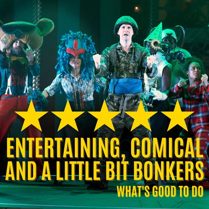 A group of actors on stage dressed as various toys, Theres a teddy bear, a baboon, an action man, a nutcracker who looks like a clown and someone wearing plaid red and blue pajamas. 