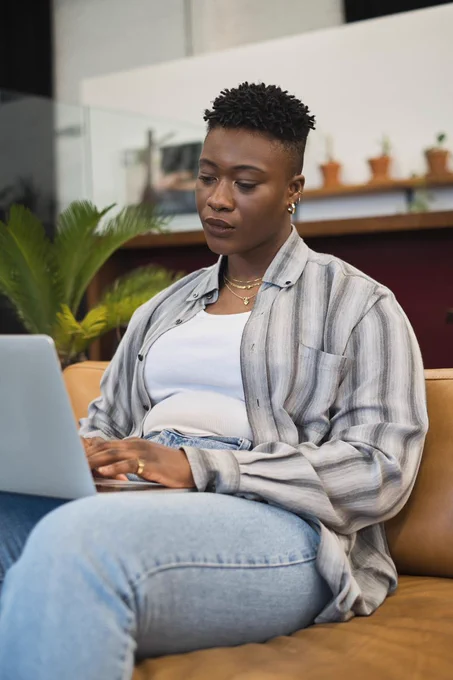 A non-binary person using a laptop at work- a Vice gender spectrum photo collection gender inclusive photo library image