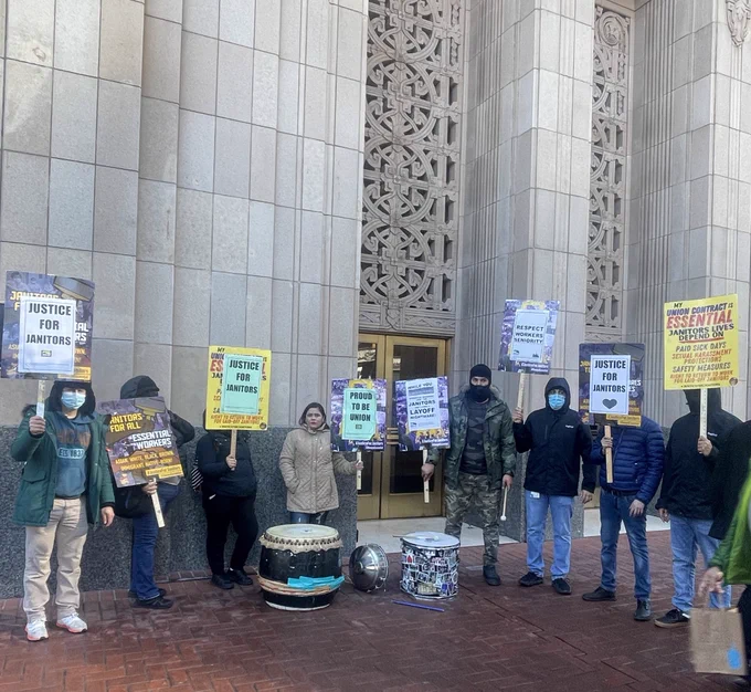Group of Janitors holding picket signs
