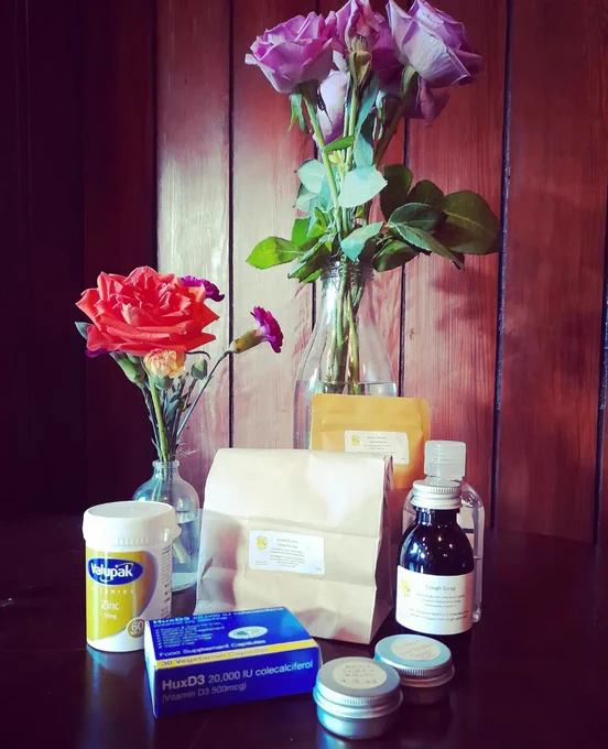 Photo of x 2 bunches of roses in jars & herbal nat congestion chest rub in tins, vitamin D packets, herbal immune system supporting syrups  etc. 