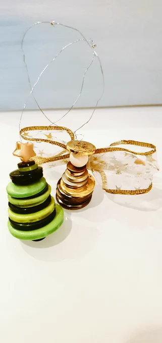 A photograph of a model of a Christmas Tree and an Angel made using buttons, ribbon and wire 