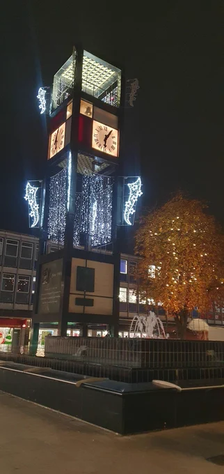 A photograph of the Stevenage Town centre clock with festive lights 