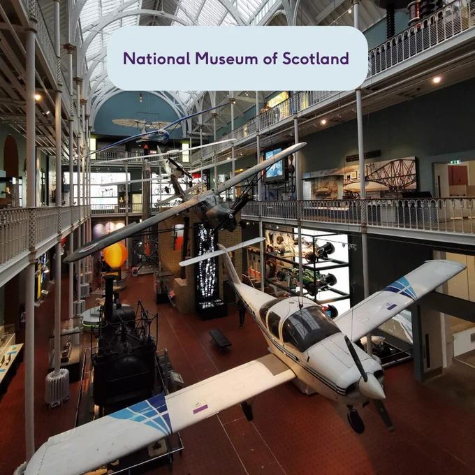 Image of the inside of the National Museum of Scotland with planes hanging from the ceiling. Text which says National Museum of Scotland.