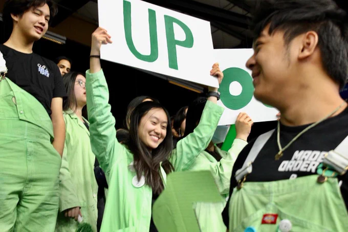 A robotics teammate holding up a sign.