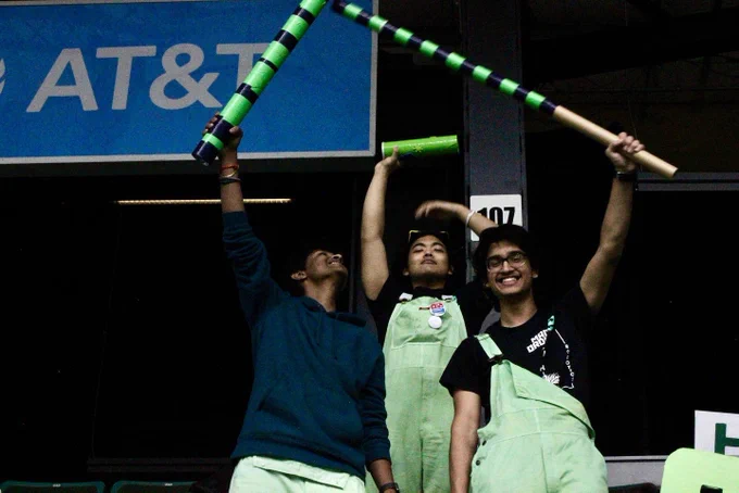Three students celebrating after a victory.