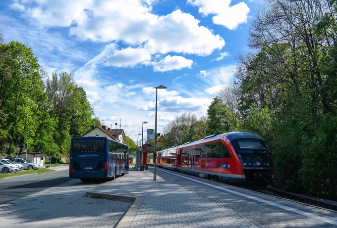 A picture of a bus and a train