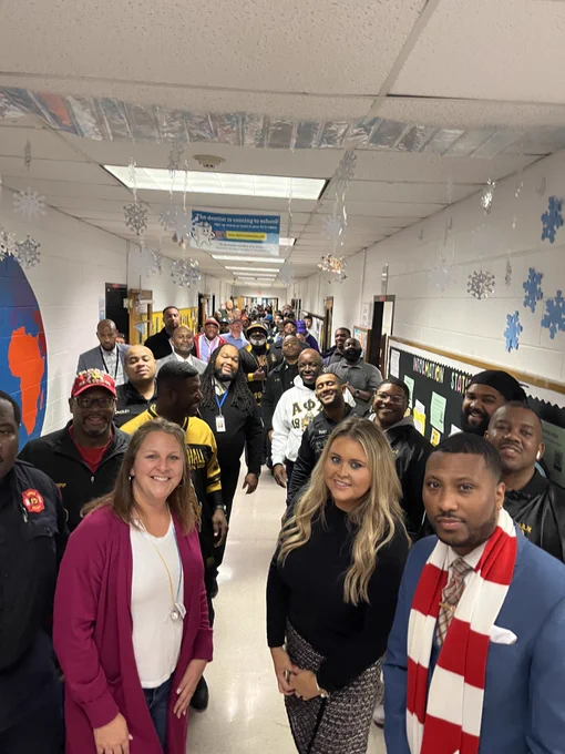 JCPS Flash Dads and school staff line the halls at Goldsmith Elementary School.