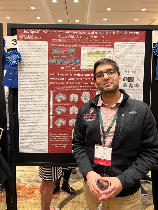 MSTP student standing in front of scientific poster display