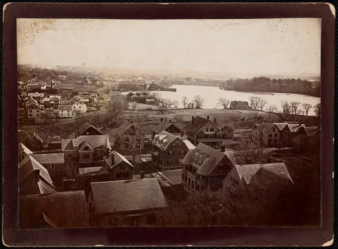 An image of Spy Pond in Arlington Center. Nearby are a few ice houses.