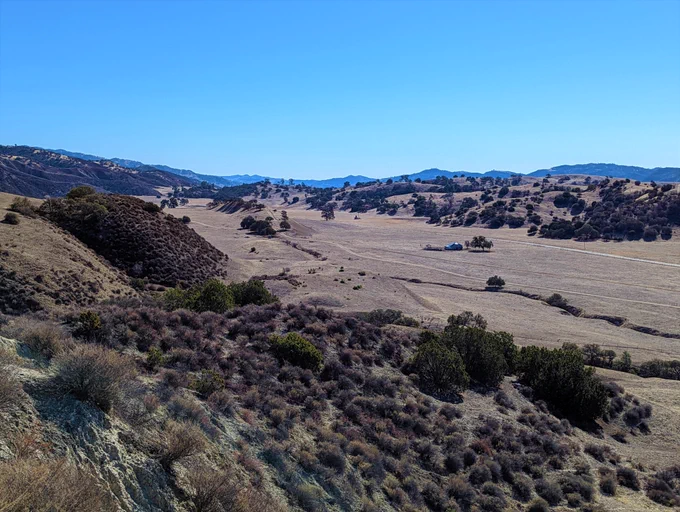 A view looking southeast along the San Andreas fault near Bitterwater, CA. Here the low elongate ridge in the middle of the valley is the expression of the San Andreas fault. The ridge and associated scarps form as the fault compresses the landscape and shuttles topography along the fault zone.