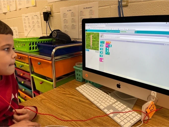 1st grade students practice coding  