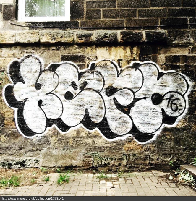 White and black graffiti on an old brick wall