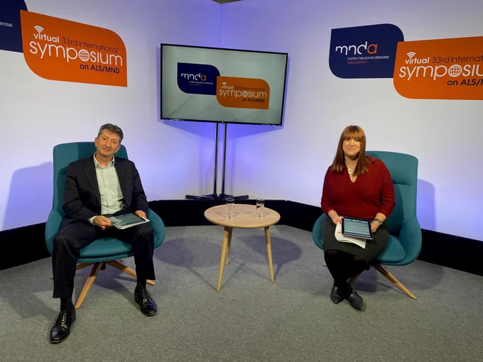 A man and woman in the tv studio set of the 33rd International Symposium on ALS/MND