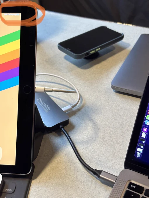 iPad attached to USB hub, which is connected to a MacBook Air and power. The iPad says it is not charging.