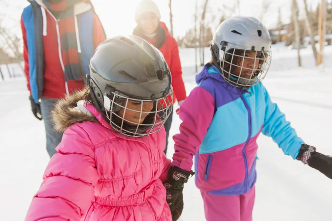 Little sisters ice-skating