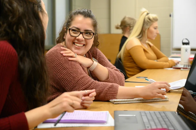 a student smiling in class