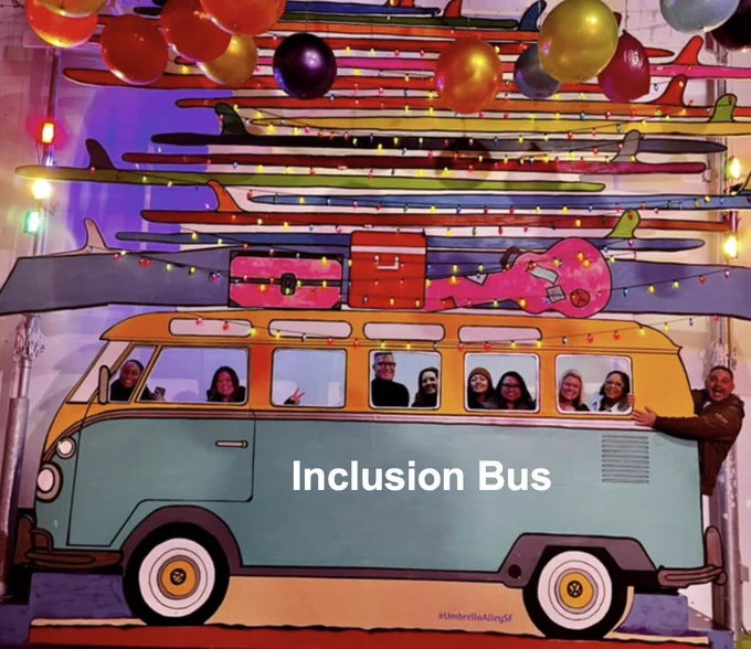 Photo of the SIP team on a colorful art installation of an inclusion bus.