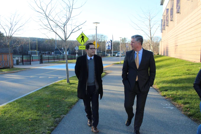 Commissioner Ortega (left) walks outside of the Wellness Center with President Barry Maloney during his tour of campus on Dec. 9, 2022. 