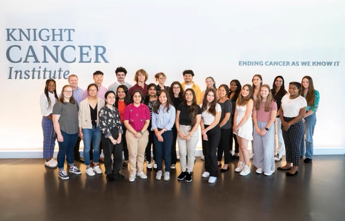 A group photo from CDCB-KCI interns inside the Knight Cancer Research Building in 2022.
