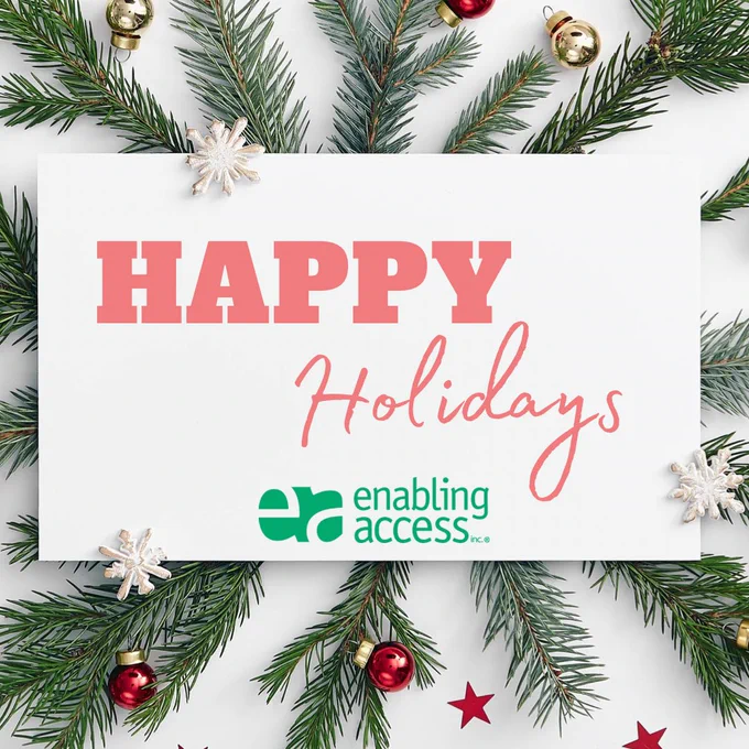 Image Description: Happy Holidays and Enabling Access Logo on white sign with Christmas tree branches in background.