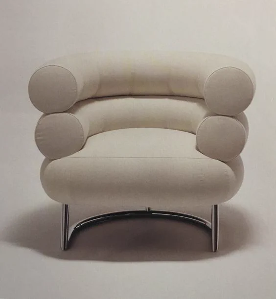 A leather and tubular steel design comprising of two rolls and a base on top of chromium painted-steel tubing. 