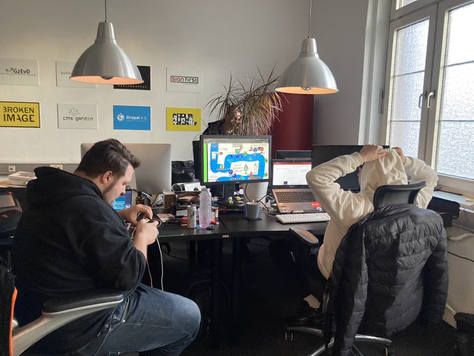 the crew behind. sitting on their chairs and stare at screens