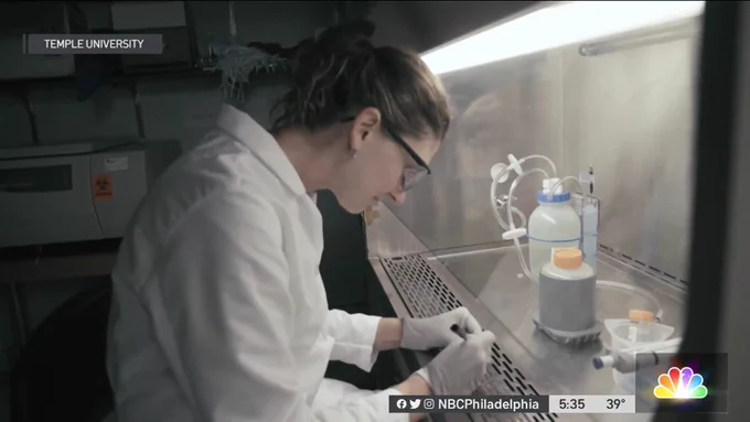 A still image from a video on NBC News Philadelphia showing Dr. Heather Murphy, Temple University and the University of Guelph, in front of a fume hood conducting tests on water samples.
