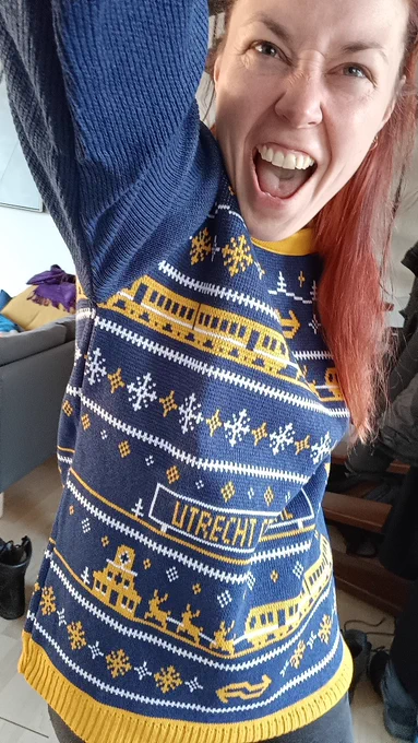 Me wearing an NS branded Christmas jumper and looking extremely excited about it