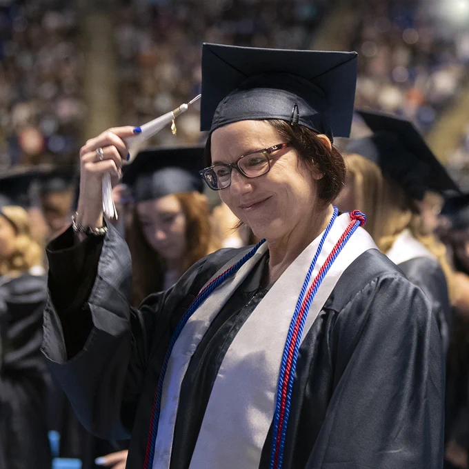 Liberal Arts graduate moving her tassel from the right to the left during the spring 2022 commencement ceremony at the Bryce Jordan Center.