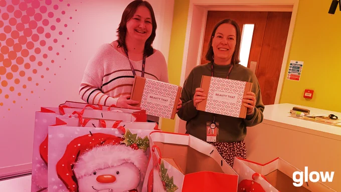 Emma and Sarah from Glow's Recovery Hub with lots of Christmas donations from Avon