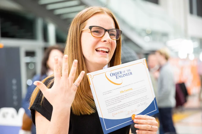 Ella Fanning smiles as she shows off her Order of the Engineer ring and certificate.