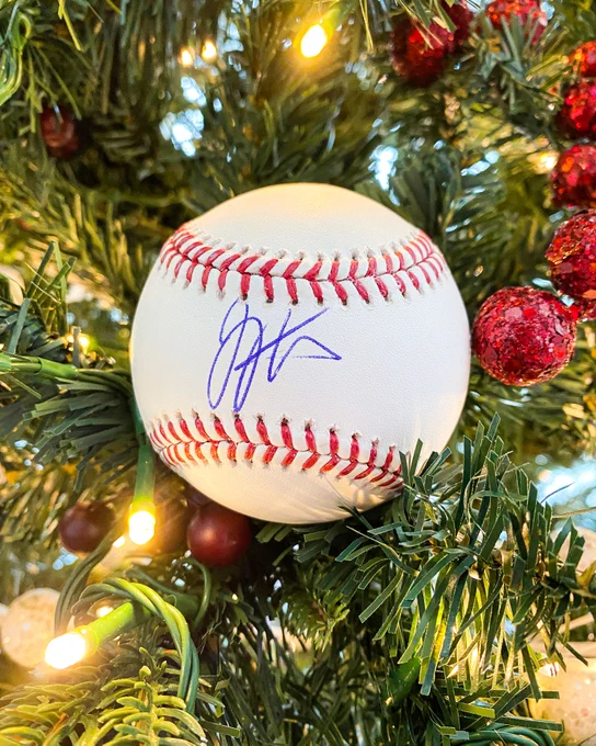 A baseball signed by Joey Votto sitting on a Christmas tree. Retweet to win!