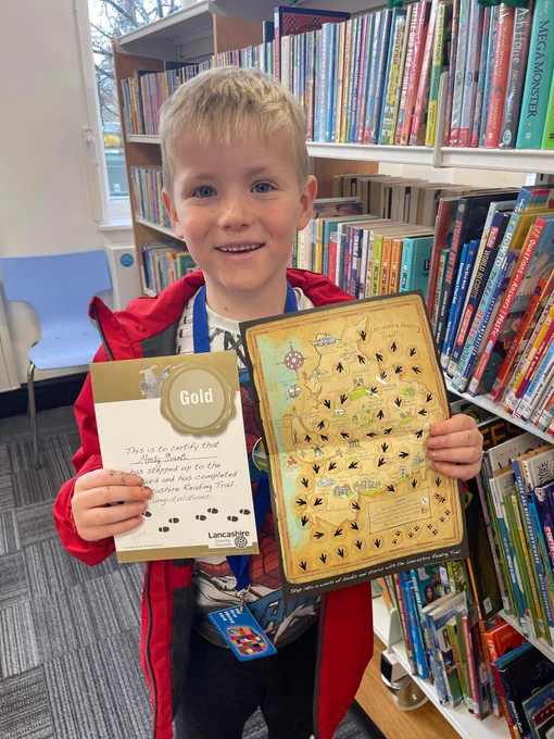 Monty holding his Reading Trail Gold certificate and the reading trail@map.