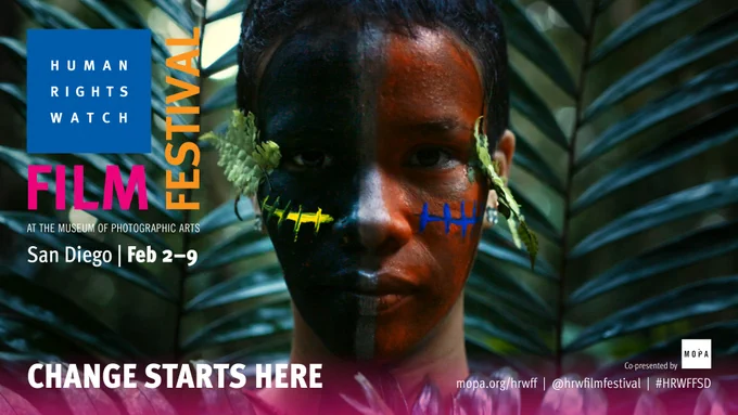 Image of person with short black hair, face painted black on left side, red on right side, white down the middle and nose. Logo reads HUMAN RIGHTS WATCH FILM FESTIVAL San Diego Feb 2-9 at Museum of Photographic Arts. 