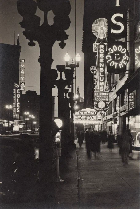 Nighttime view of "New Mall" marquee with decorative street lights and other electric signs along the Euclid Avenue sidewalk | Creator: Arthur Gray | Source: Cleveland Public Library Photograph Collection | Date: 1937