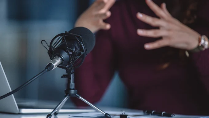 A person speaking into a microphone