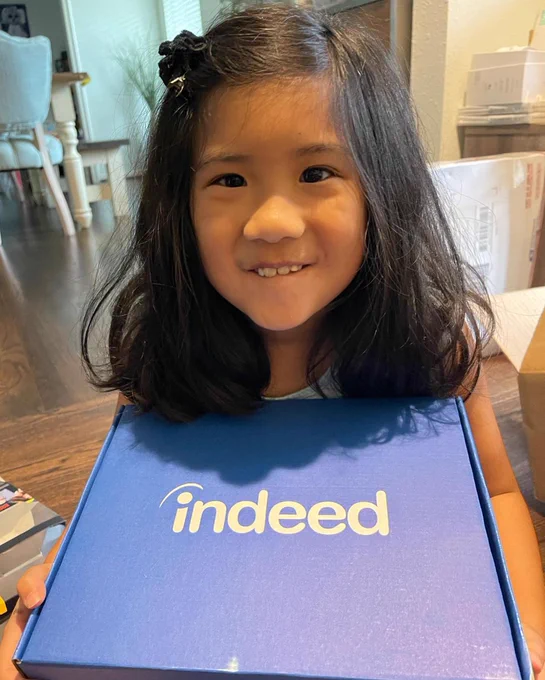 Young girl posing with Indeed notebook