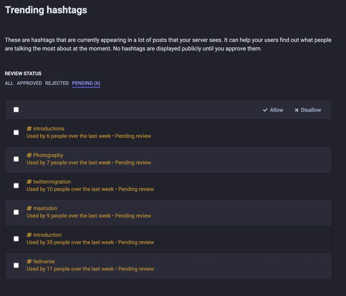 Screenshot of a Mastodon admin panel showing a list of hashtags to approve or reject. #introductions, #photography, #twittermigration, #mastodon, and #fediverse