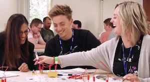 Three people taking part in physics CPD working with circuits
