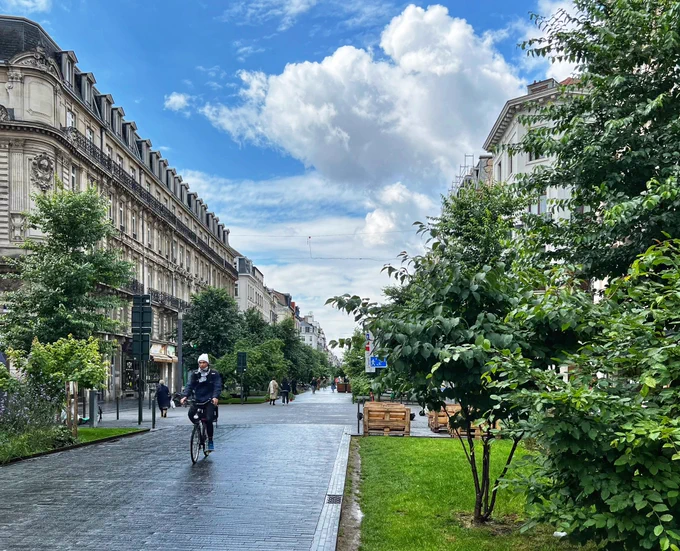 Boulevard Anspach in Brussels. Guy on a bike.