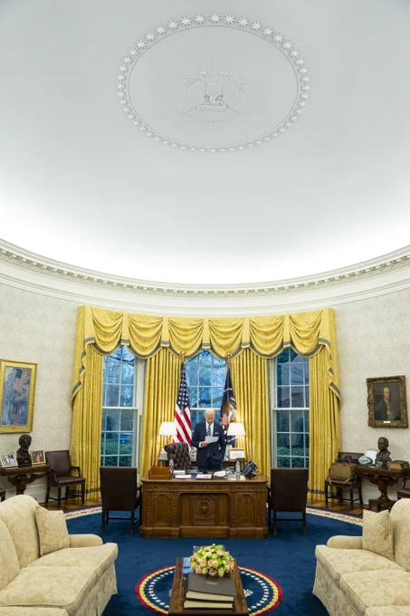 President Biden works in the Oval Office.